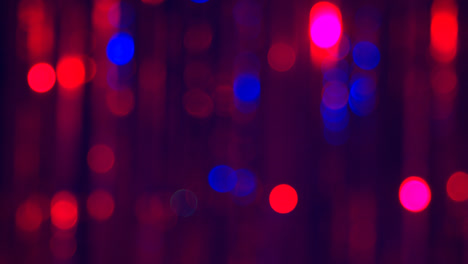 Defocused-Close-Up-Shot-Of-Sparkling-Tinsel-Curtain-In-Night-Club-Or-Disco-With-Flashing-Strobe-Lighting-1